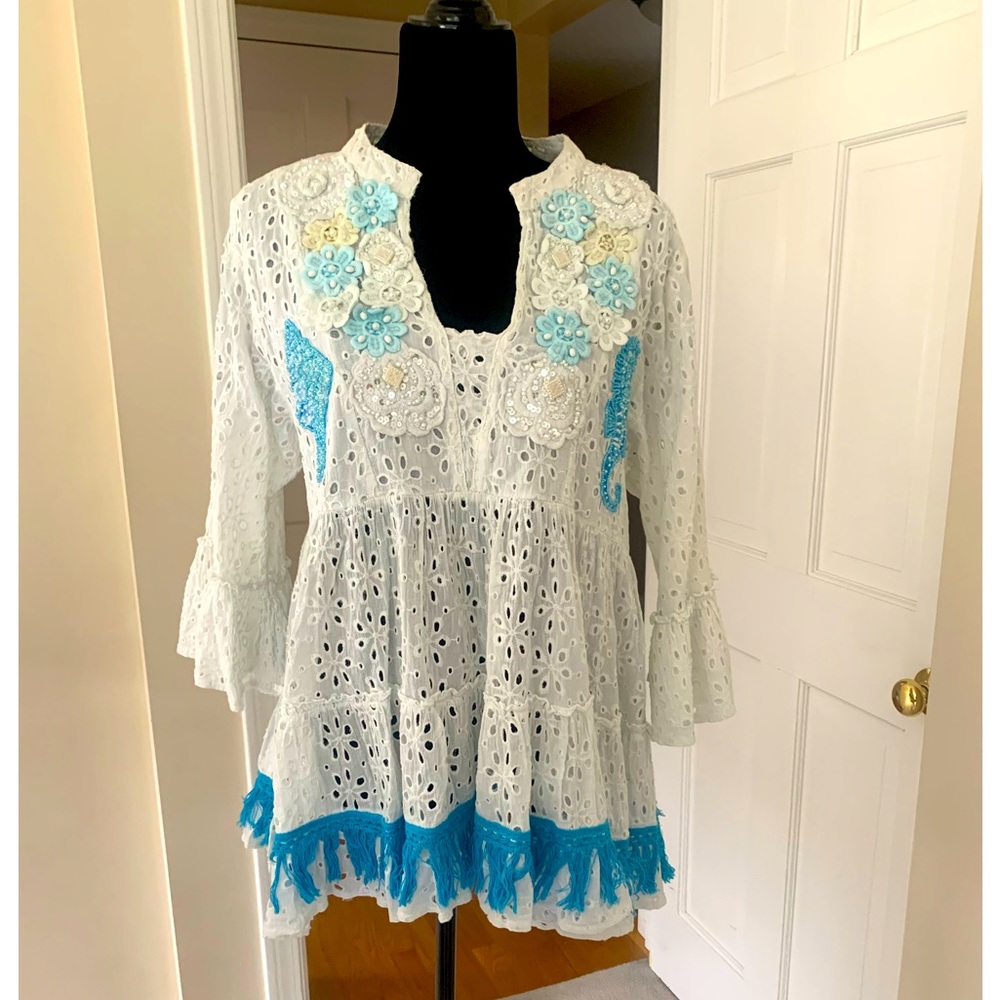 Glam boho top with beaded appliqués.